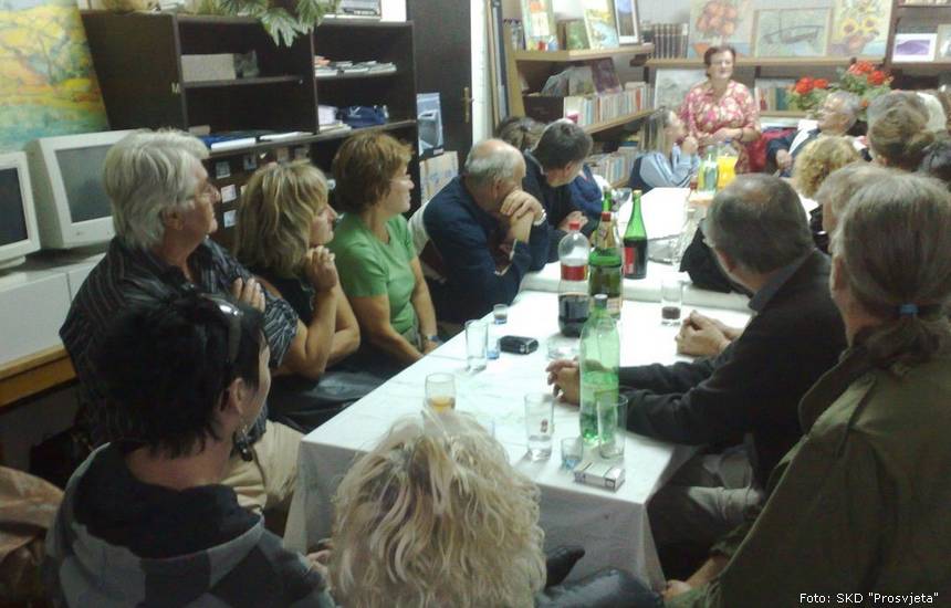 Fotografija; Likovna kolonija „Jesen u Petrinji” 2010. godine. (Radni prostor SKD „Prosvjete”, Pododbora Petrinja, koji je razornim potresima 28.12. i 29. 12. 2020. godine potpuno uništen. Krajem 9. mjeseca 2021. godine, kuća je uklonjena, time je Pododbor Petrinja ostao bez prostora, a novi još uvijek, nažalost, ne posjeduje).                        